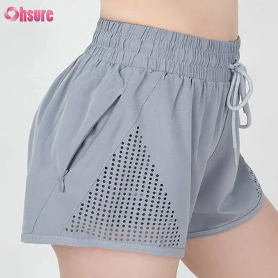 Wholesale Women's Sports Workout Shorts Breathable Laser Cut Jogging Shorts with Warm-up Zipper Side Pocket Solid Pattern