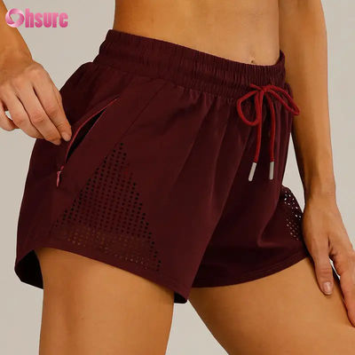 Wholesale Women's Sports Workout Shorts Breathable Laser Cut Jogging Shorts with Warm-up Zipper Side Pocket Solid Pattern